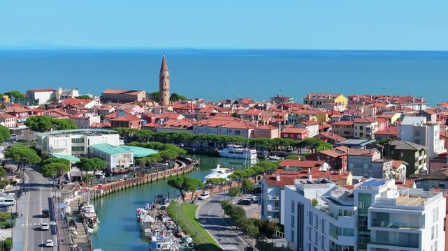 beautiful rising aerial showing Duomo di Santo Stefano Protomartire, Porto di Caorle on the Adriatic Sea