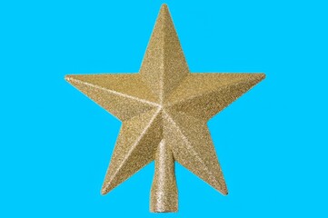 Golden Christmas Star isolated on blue Background. Top View Close-Up Gold Star render isolated on blue and clipping path