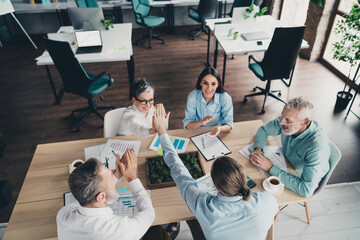 Photo high view of coworking project teamwork people sit table discuss project work together...