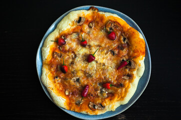 pizza with vegetables and a portrait of a baby biting pieces of pizza