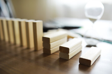 Closeup thick domino wood block in a row stop the falling, be stable in crisis, business solution...