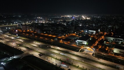 Beautiful aerial drone sky shot of night city view of the road stress, Night Scenery, Flyover, and River, which is located in Dhaka Bangladesh