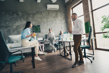 Full body photo of teamwork people working together coffee break comfortable modern office loft room interior indoors workspace