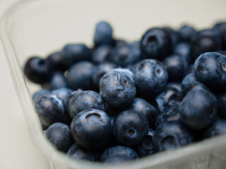 The detail shot of blueberries in a plastic packaging with a limited plane of focus