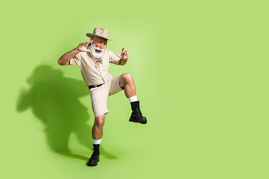 Photo of traveler man walking feel scary look down empty space wear safari suit isolated green color background - Powered by Adobe