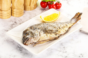 Baked Dorado fish served lemon