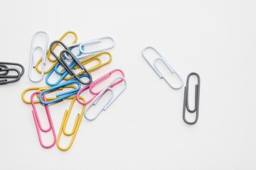 Colored office paper clips for important documents and files. White background, isolation.