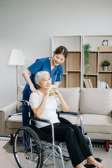 Young nurse helping elderly woman walk in the room, holding his hand, supporting. Treatment and rehabilitation after injury