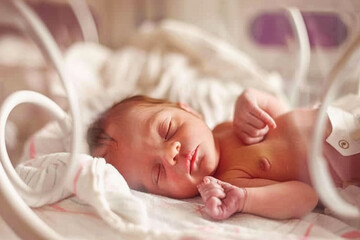 Premature infant resting in hospital incubator for neonatal care. World prematurity day, 17 november. Prematurity awareness month