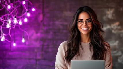 A stylish young woman wearing glasses, smiling at a laptop screen in a dark room lit by purple lights, reflecting a tech-savvy and creative environment.