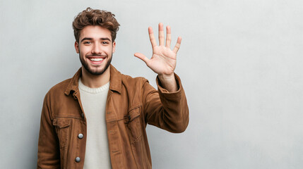 Smiling man in a spring outfit greeting with a friendly wave while promoting final reduction sales in a bright atmosphere