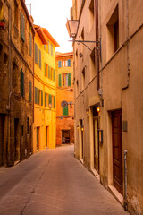 Street view in Siena, Italy with medieval houses