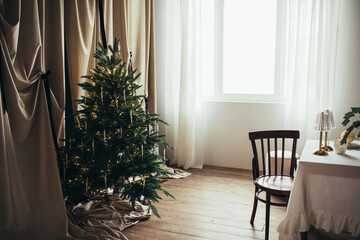 Christmas tree with festive lights in a cozy living room.