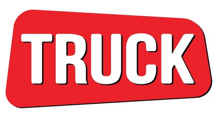 TRUCK text on red trapeze stamp sign.