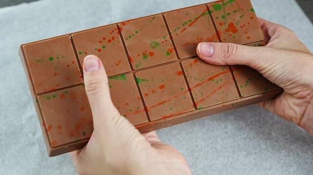 Trend Dubai chocolate with pistachio paste and kataifi dough in woman hands. Confectionery handmade sweets at home in the kitchen. 