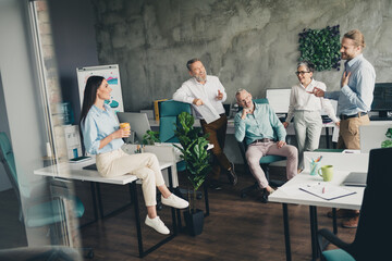 Full length photo of teamwork startup partners chatting coffee pause comfortable nice creative startup office loft room interior
