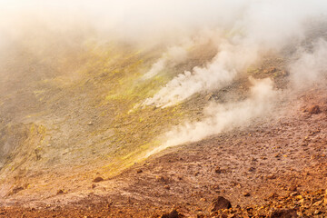 Aerial landscape view of volcano crater with smoke coming. An active erupting volcano with fumaroles in Italy, Enta and Stromboli