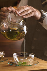 Creating perfect cup of tea is art. Mixology of creating fresh tea captured in a photo.