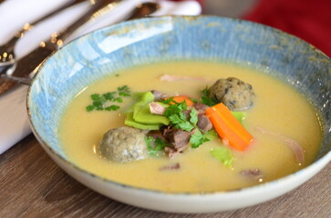 close view of traditional Czech food, Kaldoun goose soup, served food on a plate in a restaurant, wooden table, Saint Martin's goose, traditional Czech holiday food