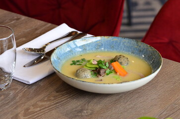 close view of traditional Czech food, Kaldoun goose soup, served food on a plate in a restaurant, wooden table, Saint Martin's goose, traditional Czech holiday food