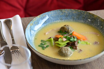 close view of traditional Czech food, Kaldoun goose soup, served food on a plate in a restaurant, wooden table, Saint Martin's goose, traditional Czech holiday food