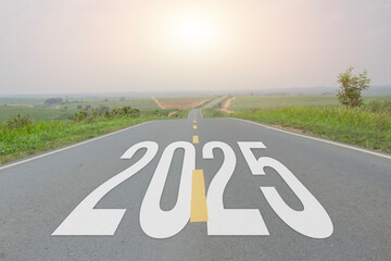 New year text 2025 written on asphalt road with view of young sugarcane plantation with sunset sky, Natural scenery with highway