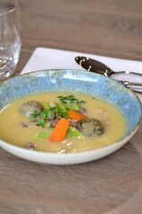 close view of traditional Czech food, Kaldoun goose soup, served food on a plate in a restaurant, wooden table, Saint Martin's goose, traditional Czech holiday food