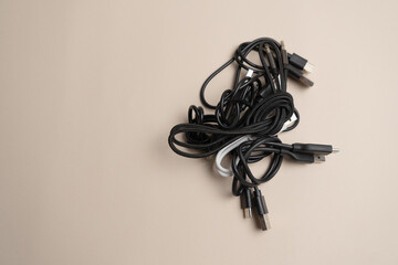 Bundle of assorted black cables tangled together, illustrating the complexity of cable management