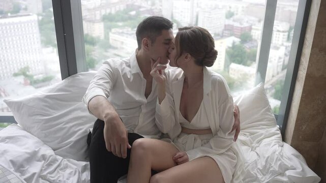 A Romantic Couple Embracing Each Other in a Chic and Stylish Hotel Room Full of Comfort