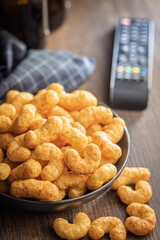 Puffed crispy Peanut flips on plate on wooden table.
