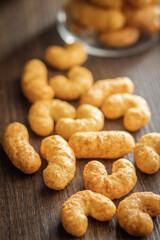 Puffed crispy Peanut flips on wooden table.