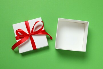 Beautiful gift box tied with red bow on color background 