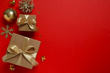 Beautiful gift boxes tied with bows and Christmas decorations on color background 