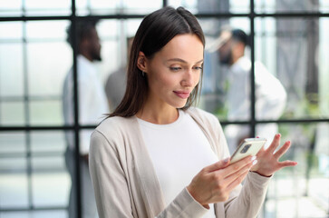 Businesswoman with phone in modern office