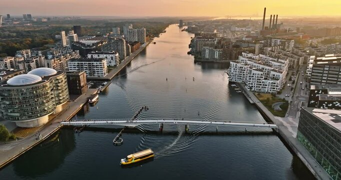 Aerial drone view of the Quay Bridge across the port of Copenhagen, Denmark at sunset