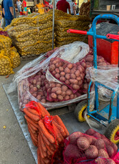 Vegetables and fruits at the bazaar, mainly potatoes, carrots, beets, in bags intended for winter supplies