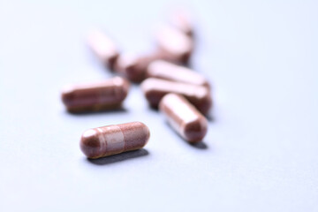 Lutein capsules. Dietary supplement on bright background. Soft focus. Close up. Copy space.