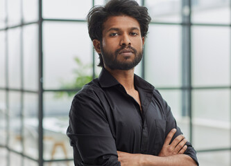 Confident Businessman in Bright Office Setting - Portrait businessman with crossed arms