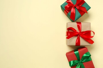 Beautiful gift boxes tied with bows on color background 