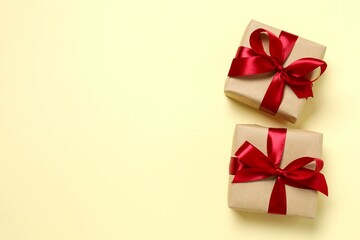 Beautiful gift boxes tied with bows on color background 
