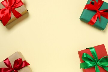 Beautiful gift boxes tied with bows on color background 