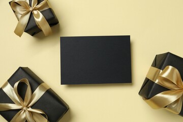 Beautiful gift boxes tied with golden bows on color background 