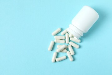 Various medicines and health pills poured from a medical white bottle, healthcare and medical top...