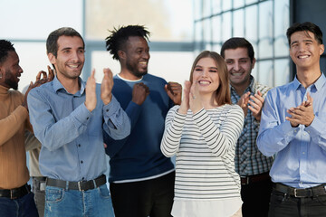 Obraz premium Human resources. Group portrait of smiling employees of a friendly team of different racial genders standing together in an office.