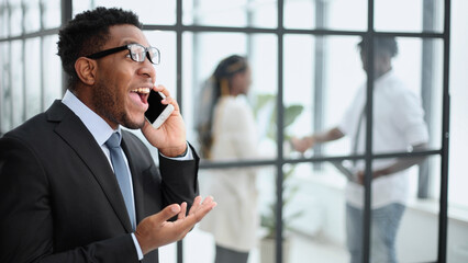 Young African American man holding his smartphone