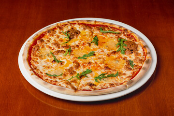 Italian pizza four cheeses on plate on wooden background