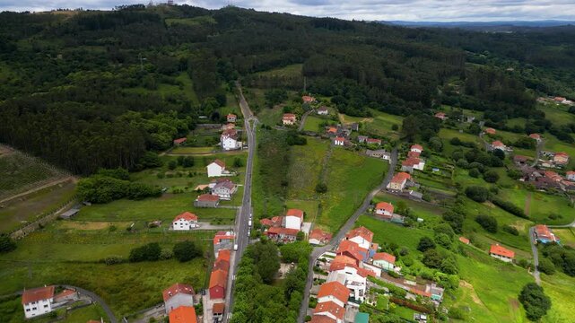 Beutiful aerial view of North Weast of Spain. Galicia landscape with green forests and hills. Small villages. Drone going forward. In background is Granxa do Xisto National Park. Travel destination.