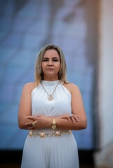 Woman in white dress poses in front of the iconic Cathedral, showcasing modern architecture.