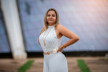 Woman in white dress poses in front of the iconic Cathedral, showcasing modern architecture.