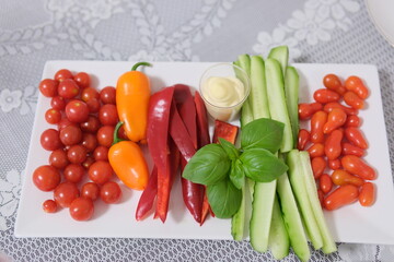 vegetables tomatoes cucumbers pepper basil. plate with vegetables. vegetable slicing